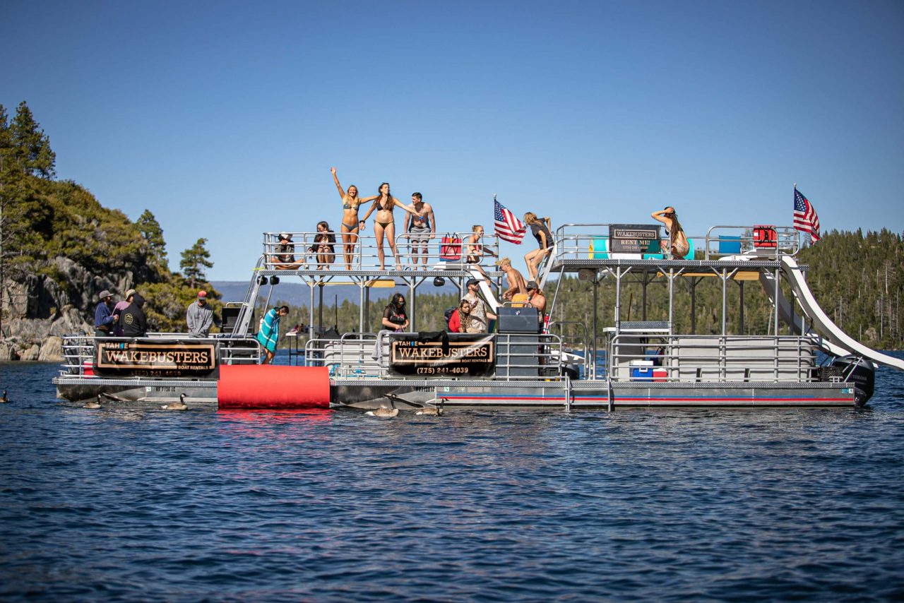 Guests tubing behind a Tahoe WakeBusters boat rental on Lake Tahoe